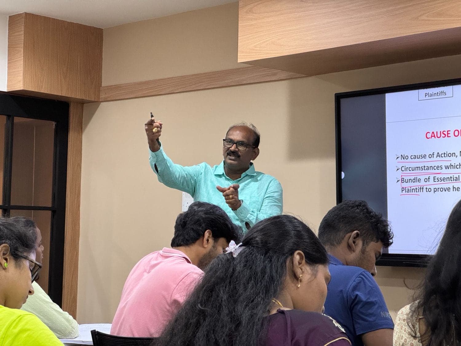 Dr. Sivakumar leading a VLS Law Academy class with a procedure slide on screen
